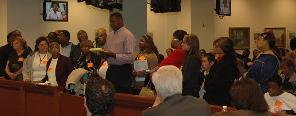 October 24, 2007. On several occasions during the October Chicago Board of Education meeting, Board President Rufus Williams asked, “Why didn’t I know about this?” when parents and others brought major problems affecting their schools to the Board’s attention. Above, Heather Obara (at microphone) who now holds the title “Chief of Operations” in addition to heading the Board’s purchasing department, tried to answer questions about the scandalous overcrowding at South Side Occupational School for disabled children. Parents from the school, who brought some of their children in wheelchairs to the Board, complained that they have been promised expanded facilities for more than ten years. Meanwhile (see, for example, pages One and Sixteen, the Board is spending millions of dollars to fix up charter and military schools. Substance photo by George N. Schmidt.